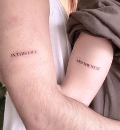 two people with tattoos on their arms that say, in this she and the next