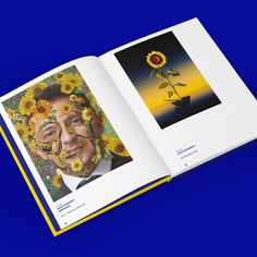 an open book with sunflowers painted on the face and in front of a blue background