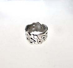 I hand carved this ring out of wax, and had it casted into sterling silver. It is one of a kind, and free form that changes pattern all the way around. The band is thick, as shown by the picture with the ruler. Hand Cast Wide Band Silver Sterling Ring, Hand Cast Sterling Silver Wide Band Ring, Unique Hand Cast Sterling Silver Engraved Ring, Hand Forged Wide Band Sterling Silver Ring, Unique Carved Sterling Silver Rings, Unique Carved Engraved Ring For Promise, Unique Hand Cast Wide Band Rings, Unique Carved Engraved Promise Ring, Unique Hand Cast Engraved Promise Ring