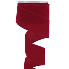 a roll of red satin ribbon on a white background