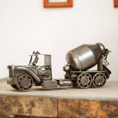 a toy truck with a cement mixer on it's flatbed is sitting on a table