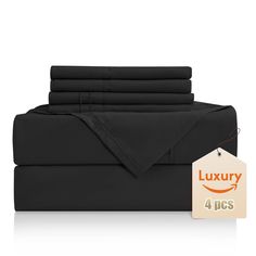 black sheets and pillowcases with a price tag for the four piece bedding set