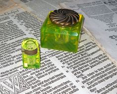 a green object sitting on top of a newspaper