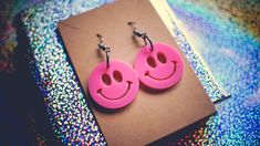 Introducing these adorable laser-cut Smiley earrings, designed to add a pop of cheer to your everyday style! Crafted from vibrant pink acrylic and assembled with hypoallergenic hooks. These earrings are as comfortable as they are eye-catching. CARE INSTRUCTIONS: ★ Please note that although these earrings are water-resistant, it is best to avoid submerging them in water to ensure their longevity.  ★ Additionally, when it comes to cleaning the acrylic, we recommend avoiding alcohol-based solutions Trendy Pink Hypoallergenic Earrings, Trendy Hypoallergenic Pink Earrings, Trendy Pink Plastic Jewelry, Fun Pink Earrings For Pierced Ears, Nickel-free Pink Novelty Earrings, Novelty Pink Nickel-free Earrings, Everyday Pink Pierced Earrings, Everyday Pink Hypoallergenic Earrings, Novelty Pink Hypoallergenic Earrings