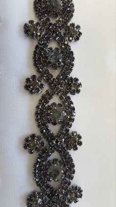 This beautiful trim is made of high-quality clear rhinestones. It is perfect for all special occasions. It can be used for wedding dress, wedding belts and sashes, bridesmaid sashes and belts hats, headbands, headpieces, flower bouquet wrap, wedding invitation, gowns, hair accessory, sash craft, jewelry, cake decoration, bags, scrapbook or any other decorations. Applying Method: Sew on, Glue on Color: rose gold black diamond -------------------- Gold Size: Width: 1 Inches Length: 1 Yard Please c Gown Belt, Rose Gold Black Diamond, Bridesmaid Sash, Wedding Sash Belt, Bouquet Wrap, Rhinestone Chain, Wedding Belts, Rhinestone Trim, Formal Gown