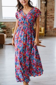 This beautiful floral print maxi dress is a must-have for any fashion-forward woman. The vibrant colors and flowy design will make you stand out in any crowd. With its comfortable fit and timeless style, the Perez dress is perfect for any occasion, whether it be a summer wedding or a day out with friends. Bring some floral flair to your wardrobe with the Perez Floral Print Maxi Dress! Material:100% Viscose Model info: Models are 5'7", Size 2, wearing smalls Colorful Floral Print V-neck Dress, Multicolor Flowy V-neck Maxi Dress, Vibrant V-neck Maxi Dress For Spring, Flowy Maxi Length Floral Dress, Multicolor Floral V-neck Dress With Vibrant Print, Flowy Multicolor Floral Dress With Vibrant Print, Multicolor Flowy Floral Dress With Vibrant Print, Modest Flowy Floral Print Midi Dress, Colorful Floral Print Maxi Dress For Summer