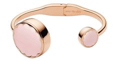 a pink cuff bracelet with an engraved heart on the front and back, in gold plating