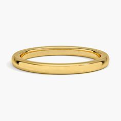 a plain gold wedding ring on a white background