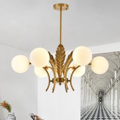 a chandelier hanging from the ceiling in a room with white walls and black and white checkered flooring