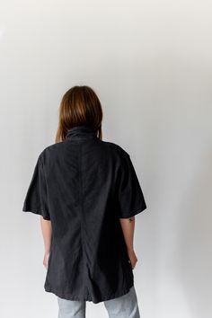 "Black short sleeve over shirt with one front chest pocket and four white buttons. Thicker over shirt material. Maker: Military | Made in USA in the 60s. Garment Dyed in Los Angeles in 2019. Material: 100% Cotton 6 oz. Condition: Excellent. may have tiny pin holes. -X SMALL- Shoulders: 17\" | Chest: 18\" | Length: 28\" | Sleeve: 10\" -SMALL- Shoulders: 17\" | Chest: 20\" | Length: 28\" | Sleeve: 10.5\" -MEDIUM- Shoulders: 18\" | Chest: 21-22\" | Length: 30\" | Sleeve: 11\" -X-LARGE- Shoulders: 2 Utility Style Short Sleeve Relaxed Fit Shirt, Utility Button-up Tops With Side Pockets, Collared Utility Tops With Button Closure, Short Sleeve Utility Tops With Pockets, Utility Short Sleeve Tops With Pockets, Utility Collared Top With Buttons, Utility Workwear Tops With Side Pockets, Utility Style Relaxed Fit Tops With Side Pockets, Utility Relaxed Fit Top With Side Pockets