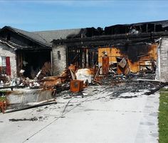 a fire damaged house that has been gutted and destroyed with debris on the ground