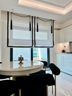 a dining room table with chairs and a chandelier hanging from it's ceiling