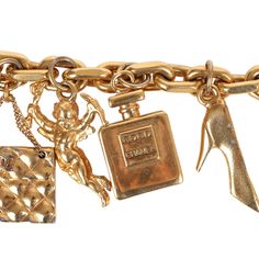 This 80's iconic vintage Chanel lucky charms bracelet features a 24K gold plated chain link with seven of Chanel's "iconic" lucky charms including a clover, shoe, perfume bottle, cherub, Chanel quilted handbag, turtle, and camellia flower. It also has a bar toggle and loop closure.Origin: FranceCondition: Vintage; Very Good - The charm bracelet shows sign of wear with scratching throughout. Some of the charms have chipped/peeled around the corners. There's some discoloration.Measurements: Length Gold Jewelry With Logo Charm For Collectors, Luxury Charm Bracelet With Logo Charm As Gift, Luxury Logo Charm Bracelet As Gift, Vintage Gold Bracelet With Logo Charm, Luxury Gold Charms With Removable Details, Luxury Gold Charms With Removable Feature, Luxury Yellow Gold Charm Bracelet With Logo, Gold Elegant Charm Bracelet, Luxury Gold Charms With Vintage Charm