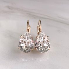 Simple, gorgeous, elegant and classic. These earrings are perfect for brides and bridesmaids! DETAILS:- Made with Swarovski crystal stones- Available in silver, gold or rose gold - 1" length- .5" width- Lightweight, easy to wear- Nickel and lead free- Securely packaged in a signature gift box- Easy returnsSHOP THE COLLECTION:https://www.etsy.com/shop/TigerlillyCouturePERSONALIZATION:We would love to personalize your earrings! On the shopping cart page, near the bottom left, is a box where you ca Classic Rose Gold Teardrop Earrings, Classic Gold Teardrop Bridal Earrings, Elegant Rose Gold Teardrop Earrings, Formal White Sparkling Teardrop Earrings, Rose Gold Teardrop Cubic Zirconia Earrings, Rose Gold Cubic Zirconia Teardrop Earrings, Elegant Rose Gold Teardrop Earrings For Anniversary, Classic Teardrop Crystal Earrings In White, Rose Gold Teardrop Earrings For Formal Occasions