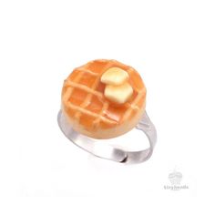 a waffle shaped ring with a banana on top