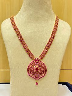 Elevate your style with our Long Handmade Necklace, infused with a touch of Indian elegance. This exquisite piece, measuring 13 inches in length, is available in five different stone options: ruby, emerald, blue sapphire, black, and pearl & coral. Each stone is carefully selected to add a unique charm to your ensemble. Crafted with precision and care by Ray Fine Ornaments Jewellery from India, our necklace boasts meticulous craftsmanship and attention to detail. With 22k yellow gold plating, it Ruby Necklace With Intricate Design For Celebration, Elegant Ruby Jewelry For Puja, Cutdana Necklaces For Receptions, Elegant Hand Set Temple Necklace For Puja, Ruby Necklaces For Diwali Celebration, Elegant Chain Necklace For Wedding And Festivals, Traditional Ruby Necklaces For Diwali, Long Necklace With Intricate Design For Diwali, Elegant Festive Necklace For Puja