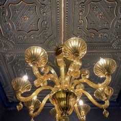 a gold chandelier hanging from the ceiling