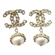 Chanel Gold Chain CC Pearl Dangle Piercing Earrings  * Marked 16 * Made in Italy * Comes with the original box  – Approximately 0.75″ x 1.3″ – Great for any event – In a pristine condition  AB4116-00471  Please see the measurements section for best approximate dimensions. Elegant Formal Earrings With Chain Detail, Elegant Chain Earrings For Formal Occasions, Silver Chain Earrings For Wedding, Formal Chain Drop Earrings, Luxury Metal Pearl Drop Earrings, Luxury Pearl Drop Metal Earrings, Luxury Metal Jewelry With Pearl Drop, Designer Pierced Dangle Jewelry, Formal Chain Metal Earrings