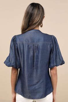 Bring a chic vibe to your everyday looks with the Lulus Contemporary Crush Dark Blue Chambray Puff Sleeve Button-Up Top! Lightweight woven chambray fabric shapes this stylish top that has pleated-like detailing at the shoulders and short puff sleeves with elastic at the cuffs. Crew neckline tops a functional, hidden button placket that runs down the bodice to rounded hems. Fit: This garment fits true to size. Length: Size medium measures 25" from shoulder to hem. Bust: Great for any cup size. Wa Denim Blue Button-up Workwear Blouse, Summer Button-up Tops With Blouson Sleeves, Summer Puff Sleeve Denim Top, Trendy Cotton Tops With Blouson Sleeves, Trendy Cotton Blouse With Blouson Sleeves, Blue Denim Blouse With Puff Sleeves, Fitted Denim Top With Puff Sleeves, Fitted Denim Top For Workwear, Chic Denim Blue Workwear Blouse