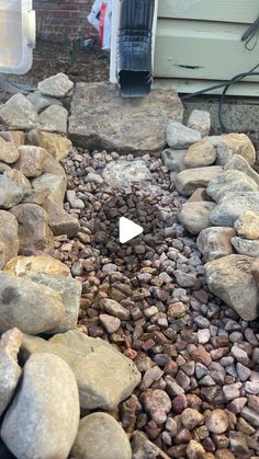 a rock garden with rocks and gravel around it