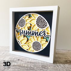 a shadow box with the word summer cut out and sunflowers in it on a wooden surface