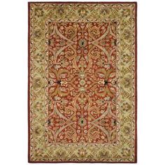 an orange and green rug with intricate designs on it's border, in the middle of