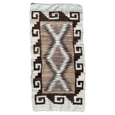 a rug with brown and white designs on it's sides, in front of a white background