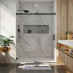 a bathroom with a walk in shower next to a sink