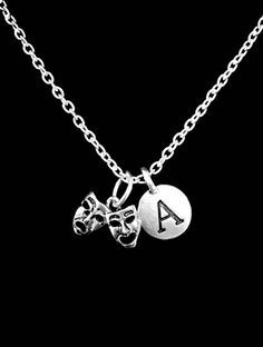 The charms are silver color. The mask charm is approx 12mm x 16mm. The chain is silver plated link chain and is 18" long. Has lobster clasp closure on the chain. Charms are Pewter. Chain made of silver plated alloy. Gorgeous!!!-Ships with gift packaging.-Invoices are not included in packages unless requested.-Birthstone charms can be purchased for this piece with this link:  https://www.etsy.com/listing/195923344-Initial/ Letter charms can be purchased for this pieces with this link:  https://ww Mardi Gras Necklace, Theater Mask, Mother Daughter Necklaces Set, Tragedy Mask, Theatre Masks, Comedy And Tragedy, Mother Daughter Necklace, Mask Necklace, Best Friend Jewelry