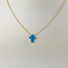 Description Simple. Chic. Minimalist™ A perfectly dainty brilliant synthetic fiery blue opal cross is floating freely on a delicate feminine 14k gold plated over Sterling silver chain. This cute and tiny star charm necklace features a synthetic created blue opal moon stone with sterling silver chain. This lovely star necklace is perfect for complementing a casual outfit, and you can even layerbit with other necklace to create something unique. * High Quality 925 Sterling Silver link chain with s Blue Cross Necklace, Opal Jewelry With Delicate Chain As Gift, Delicate Opal Chain Jewelry Gift, Delicate Opal Chain Jewelry As Gift, Delicate Opal Chain Jewelry For Gifts, Gold Hypoallergenic Opal Jewelry, Hypoallergenic Gold Opal Jewelry, Blue Pendant Cross Necklace Gift, Blue Opal Pendant Jewelry