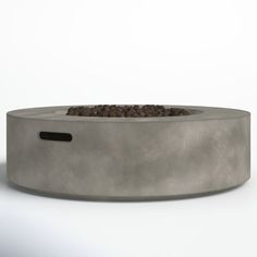 a concrete fire pit with rocks in it