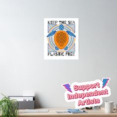 an image of a poster on the wall next to a desk with a potted plant