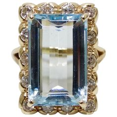 Elevate your evening looks with this stunning Aquamarine cocktail ring! Circa mid-20th century and set in a split style 18k Gold band, this Victorian style ring features an Aquamarine baguette cut center gemstone at approximately 12 carats with a frame of brilliant round cut Diamonds. Total weight in grams is 9.25 and was made to fit a size 7. A true vintage treasure, this ring will pair perfectly with your favorite Dior evening dress and Chanel clutch! Dior Evening Dress, Diamond Baguette Ring, Aquamarine Cocktail Ring, Victorian Style Rings, Victorian Jewellery, Chanel Clutch, Baguette Diamond Rings, Baguette Ring, Victorian Jewelry