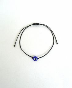 The evil eye is used to protect the person that wears it from the malevolent look of others who envy or dislike that person. This macrame bracelet is made out of black waxed string. 8mm flat eye glass bead At the end it is adorned with blue glass seed beads. It is adjustable to fit a lot of sizes. Other evil eye bracelets in my shop: https://www.etsy.com/shop/LuckyRatJewellery?section_id=14785936&ref=shopsection_leftnav_5 *Colours may differ slightly from the original due to the configuratio Evil Eye Bracelet Png, Affordable Black Beaded Evil Eye Bracelet, Cheap Black Evil Eye Bracelet, Bracelets Eye Evil, Minimalist Evil Eye Bracelet For Everyday, Minimalist Round Evil Eye Bracelet, Minimalist Evil Eye Bracelet, Minimalist Adjustable Beaded Bracelets With Evil Eye, Minimalist Adjustable Evil Eye Bracelet