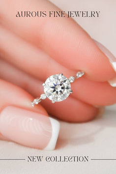 a woman's hand holding a diamond ring with the words new collection on it