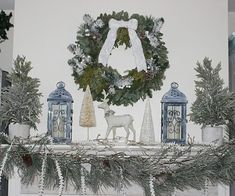 a mantel decorated for christmas with candles, ornaments and deer figurines on it