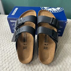 New With Tags In Box. Birkenstock Women’s Arizona Footbed Sandal. Black In Size 6 (European 37). Retail $110. Faux Leather Birko-Flor Upper In A Casual Footbed Sandal Style With An Open Toe Synthetic Leather-Like Finish With Felt-Lined Backing Wipes Clean With Mild Soap And Water Twin Adjustable Buckled Straps For The Iconic Birkenstock Look Slide Entry Smooth Lining, Classic Birkenstock Footbed Featuring Pronounced Arch Support And A Deep Heel Cup Flexible, Shock Absorbing Eva Outsole All Arizo Black Flat Slides With Cork-bed Midsoles, Classic Black Footbed Sandals With Round Toe, Classic Black Footbed Sandals For Beach, Burken Stocks Shoes, Birkenstock Outfit Summer, Black Birkenstocks, Birkenstock Outfit, Birkenstock Black, Sandal Style