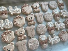 decorated cookies in the shape of teddy bears with name and age on each cookie sheet