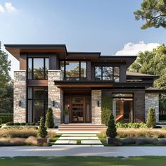 a modern house with lots of windows and stone steps leading up to the front door