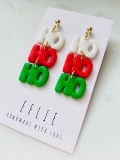 the earrings are red, green and white with letters on them that read effiee handmade with love