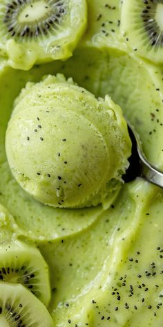 kiwi ice cream in a bowl topped with sliced kiwis