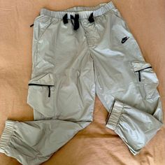 Beautiful Sporty Nike Pants Size Large Stretch Style Nike Nylon Bottoms, Nike Nylon Long Pants, Casual Nike Nylon Bottoms, Nike Casual Nylon Bottoms, Nike Casual Nylon Parachute Pants, Nike Casual Pants For Spring, Nike Nylon Pants With Pockets, Nike Pants, Tapered Legs