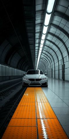 a car driving through a tunnel with an orange floor