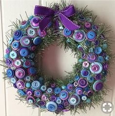 a wreath with purple and blue buttons on it