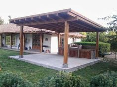 a covered patio with an outdoor kitchen and grill area