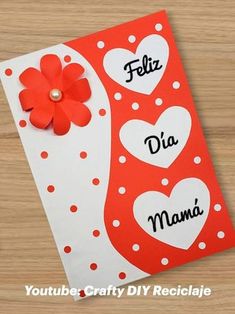 a red and white card with hearts on it that says feliz dia mama