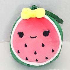 a stuffed watermelon with a bow on it's head