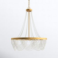 a chandelier with pearls hanging from the ceiling