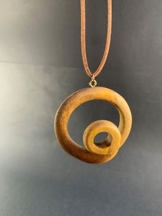 ** Spiral Pendant ** Diameter: 55 mm  Depth : 25mm This unique spiral pendant pine tree wood.  It comes with Korean waxed cord and has lobster clasp at the end. For custom necklace lengths send me a message. If you have any questions about this item or any other items in my shop , message me and I will be more than happy to help. --------------------------------------- HOW LONG CAN YOU PREPARE AND SEND MY PRODUCT? --------------------------------------- This period is 1 to 2 working days at most, depending on the order density. We usually ship your orders on the same day or 1 day later at the latest. Your product is carefully packed and shipped. --------------------------------------- You can give this unique necklace as a gift to your loved ones;  Gifts for Boyfriend Gifts for Dad Gifts f Wooden Jewelry Handmade, Valentines Birthday, Jewelry Classic, Handmade Pendant Necklace, Mask Necklace, Chess Sets, Brown Necklace, Wooden Necklace, Minimalist Gifts