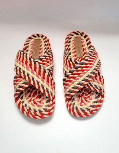 our 100% vegan rope slide made from natural plant based fabric - woven into ropes and hand-applied for a very unique sandal slide in an array of beautiful reds, pinks and naturals. Outsole is made from durable TPR.Upper: FabricLining: Vegan PUInsole: FabricOutsole: TPRNew and Improved fitting! Fit has been adjusted from last year and fit is now true to size- length is about 1/4 inch longer than last year.Made In India Casual Braided Sandals In Natural Color, Casual Beach Sandals With Rope Detail, Pink Straw Sandals For Summer, Multicolor Woven Sandals For Summer, Pink Straw Sandals With Woven Sole, Adjustable Woven Natural Sandals, Vacation Handwoven Straw Sandals, Multicolor Woven Open Toe Sandals, Handwoven Sandals For Spring Vacation